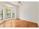Light-filled bedroom featuring wood floors, arched windows, and neutral decor, offering a peaceful retreat at 9180 Sw 202Nd Avenue Rd, Dunnellon, FL 34431