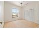 Comfortable bedroom with neutral carpet, closet with bi-fold doors, and ample natural light at 9180 Sw 202Nd Avenue Rd, Dunnellon, FL 34431