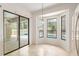 Dining nook with large windows and sliding glass doors offering a view of the backyard pool at 9180 Sw 202Nd Avenue Rd, Dunnellon, FL 34431