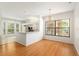 Bright dining room with hardwood floors and view to kitchen at 9180 Sw 202Nd Avenue Rd, Dunnellon, FL 34431
