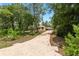 The long driveway leads up to this home surrounded by lush greenery at 9180 Sw 202Nd Avenue Rd, Dunnellon, FL 34431
