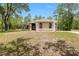 Charming single story home with neutral stucco, arched windows, and lush trees in a beautiful, private setting at 9180 Sw 202Nd Avenue Rd, Dunnellon, FL 34431