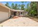Inviting home with brick driveway, attached garage, and lush landscaping; perfect for peaceful suburban living at 9180 Sw 202Nd Avenue Rd, Dunnellon, FL 34431