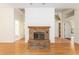 Brick fireplace with hardwood floors and view of front door at 9180 Sw 202Nd Avenue Rd, Dunnellon, FL 34431