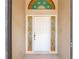Elegant front door with side lights features decorative glass and trim at 9180 Sw 202Nd Avenue Rd, Dunnellon, FL 34431