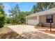 Paved driveway and attached garage offering convenience and plenty of parking space at 9180 Sw 202Nd Avenue Rd, Dunnellon, FL 34431