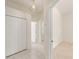 Bright hallway with tile floors connects closets, rooms, and bathroom access at 9180 Sw 202Nd Avenue Rd, Dunnellon, FL 34431