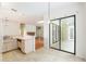 Kitchen with stainless steel sink, tile floor, and view of the sliding doors to outdoor living space at 9180 Sw 202Nd Avenue Rd, Dunnellon, FL 34431