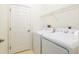 Functional laundry room features a washer, dryer, and overhead storage rack at 9180 Sw 202Nd Avenue Rd, Dunnellon, FL 34431