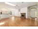 Bright living room features a fireplace, skylight, and hardwood floors at 9180 Sw 202Nd Avenue Rd, Dunnellon, FL 34431