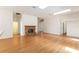 Open-plan living room with fireplace and hardwood floors and skylight at 9180 Sw 202Nd Avenue Rd, Dunnellon, FL 34431