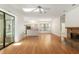 Living room with hardwood floors, fireplace, open layout, and view of kitchen at 9180 Sw 202Nd Avenue Rd, Dunnellon, FL 34431