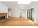 Living room with hardwood floors, fireplace, and access to kitchen and pool at 9180 Sw 202Nd Avenue Rd, Dunnellon, FL 34431