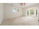 Spacious main bedroom features large windows, carpet, and neutral colors at 9180 Sw 202Nd Avenue Rd, Dunnellon, FL 34431