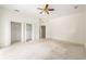 Spacious main bedroom features carpet, double closets, and neutral colors at 9180 Sw 202Nd Avenue Rd, Dunnellon, FL 34431