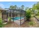 Screened pool with brick patio, surrounded by lush landscaping and providing privacy at 9180 Sw 202Nd Avenue Rd, Dunnellon, FL 34431
