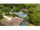 Lush backyard featuring a screened-in pool and well-maintained lawn among trees at 9213 Sw 197Th Cir, Dunnellon, FL 34432