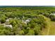 Lush aerial view of a home nestled among dense trees in a rural, wooded neighborhood at 9213 Sw 197Th Cir, Dunnellon, FL 34432