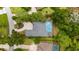 Aerial view of a house with a kidney-shaped pool with a fountain, surrounded by trees at 9213 Sw 197Th Cir, Dunnellon, FL 34432