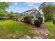 Scenic backyard view with a screened pool and spa enclosure and a gazebo, set against a backdrop of lush greenery at 9213 Sw 197Th Cir, Dunnellon, FL 34432