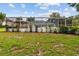 Well-maintained lawn and landscaping framing the screened-in pool area and gazebo for outdoor enjoyment at 9213 Sw 197Th Cir, Dunnellon, FL 34432