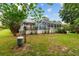 Spacious backyard featuring a screened pool enclosure and a charming gazebo, perfect for relaxation and entertainment at 9213 Sw 197Th Cir, Dunnellon, FL 34432