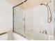 The bathroom features a shower with a glass enclosure and a white tiled tub surround at 9213 Sw 197Th Cir, Dunnellon, FL 34432