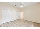 Bright bedroom features a ceiling fan, fresh paint, modern laminate flooring, and ample closet space at 9213 Sw 197Th Cir, Dunnellon, FL 34432