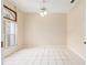 Bedroom with white tile flooring, a ceiling fan, and a window letting in natural light at 9213 Sw 197Th Cir, Dunnellon, FL 34432