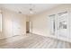 Light-filled bedroom featuring double doors to the patio, a ceiling fan, and wood laminate flooring at 9213 Sw 197Th Cir, Dunnellon, FL 34432