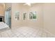 Dining Room features tile flooring, large windows, and sliding doors to backyard area with pool at 9213 Sw 197Th Cir, Dunnellon, FL 34432