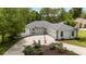 Charming single-story home featuring a circular driveway, mature landscaping, and a classic brick and siding facade at 9213 Sw 197Th Cir, Dunnellon, FL 34432