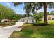 Well-manicured front yard leads to a charming home with a long driveway at 9213 Sw 197Th Cir, Dunnellon, FL 34432