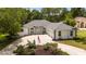 Stunning single-story home with manicured landscaping, a circular driveway, and an American flag at 9213 Sw 197Th Cir, Dunnellon, FL 34432