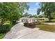 Charming home featuring a well-manicured lawn, a long driveway and an american flag at 9213 Sw 197Th Cir, Dunnellon, FL 34432