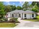 Charming home featuring a well-manicured lawn and beautiful landscaping, plus lots of curb appeal at 9213 Sw 197Th Cir, Dunnellon, FL 34432