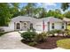 Charming home featuring a well-manicured lawn, a long driveway and an american flag at 9213 Sw 197Th Cir, Dunnellon, FL 34432