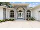 Arched brick facade frames a glass front door and arched windows, creating an inviting entrance at 9213 Sw 197Th Cir, Dunnellon, FL 34432