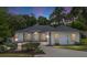 Charming home featuring a well-manicured lawn, a long driveway and an american flag at 9213 Sw 197Th Cir, Dunnellon, FL 34432