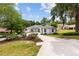 Charming home featuring a well-manicured lawn, a long driveway and an american flag at 9213 Sw 197Th Cir, Dunnellon, FL 34432