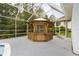 Wooden gazebo within a screened pool enclosure, offering a shaded retreat for relaxation and entertainment at 9213 Sw 197Th Cir, Dunnellon, FL 34432