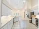 Bright kitchen features white cabinetry, island, and stainless steel appliances at 9213 Sw 197Th Cir, Dunnellon, FL 34432