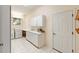 Well-lit laundry room with ample counter space, cabinets, a window, and a washer and dryer at 9213 Sw 197Th Cir, Dunnellon, FL 34432