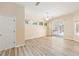 Open living room boasts wood floors, sliding glass doors, and lots of natural light at 9213 Sw 197Th Cir, Dunnellon, FL 34432