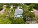 Aerial view of a house with a screened-in pool surrounded by lush greenery at 9213 Sw 197Th Cir, Dunnellon, FL 34432