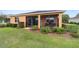 Landscaped home exterior with screened in porch and lush, well maintained lawn at 9236 Sw 91St Court Rd, Ocala, FL 34481