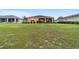 Manicured backyard featuring lush grass and mature landscaping with a screened-in porch at 9236 Sw 91St Court Rd, Ocala, FL 34481
