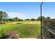 A beautiful backyard with a lush green lawn and serene golf course views at 9236 Sw 91St Court Rd, Ocala, FL 34481
