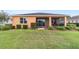 Beautiful home exterior with screened in porch and lush, landscaped backyard at 9236 Sw 91St Court Rd, Ocala, FL 34481