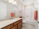 Bathroom with granite vanity, white tiled shower and tub, and neutral tiled floors at 9236 Sw 91St Court Rd, Ocala, FL 34481